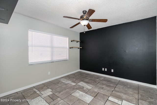 unfurnished room with plenty of natural light, a textured ceiling, and ceiling fan