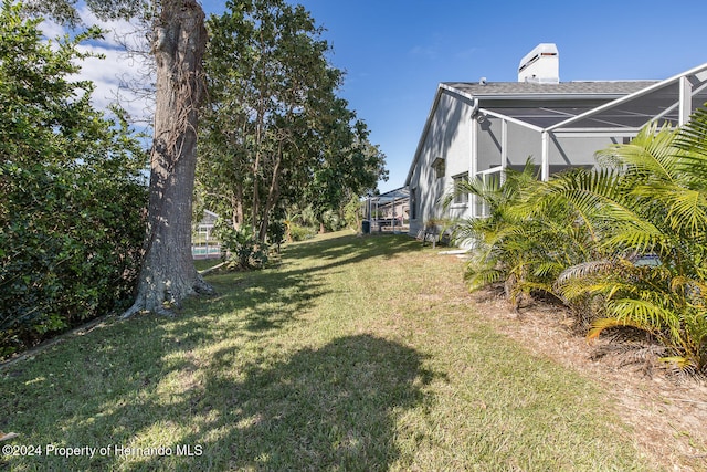 view of yard featuring a lanai