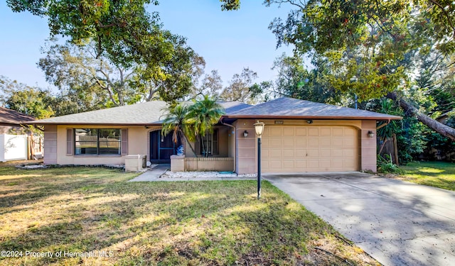 single story home with a garage and a front lawn