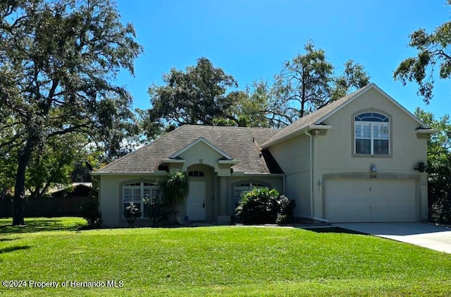 view of front of home featuring a garage and a front lawn