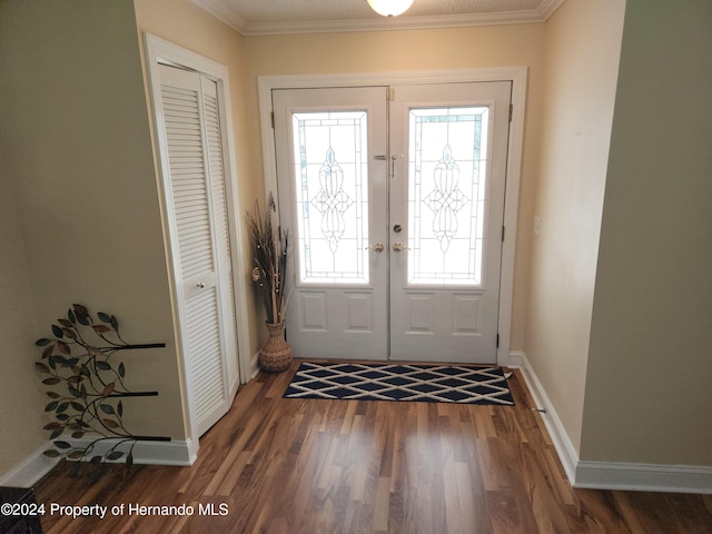 doorway featuring dark wood-type flooring, a wealth of natural light, french doors, and ornamental molding