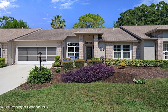 ranch-style home featuring a garage and a front yard