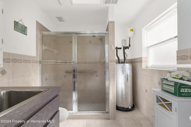 8016 Bellevista Ct, Spring Hill, FL 34606 - full bathroom featuring tile walls, water heater, tile patterned flooring, a stall shower, and wainscoting