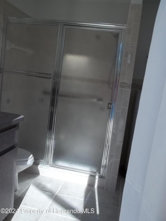 8016 Bellevista Ct, Spring Hill, FL 34606 - full bathroom featuring a stall shower, toilet, tile patterned flooring, and vanity