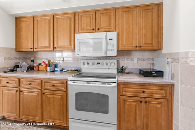 8016 Bellevista Ct, Spring Hill, FL 34606 - kitchen featuring white appliances, light countertops, and brown cabinetry