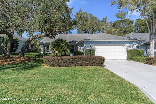 single story home with a garage and a front lawn