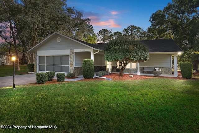 ranch-style home featuring a lawn