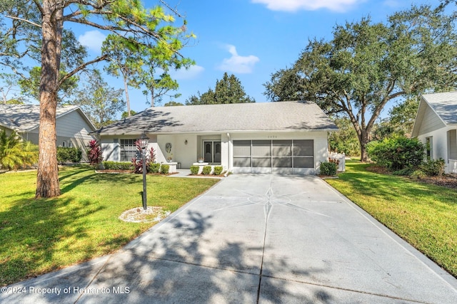 single story home with a garage and a front lawn