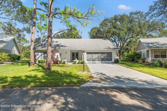 single story home featuring a front yard and a garage