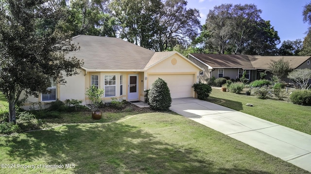 3472 Hartley Rd, Spring Hill, FL 34606 - ranch-style house featuring a garage, concrete driveway, stucco siding, and a front lawn