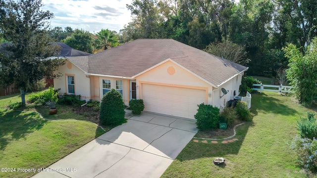 ranch-style home featuring a garage and a front lawn