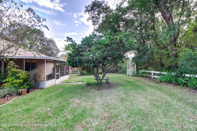 view of yard featuring a sunroom