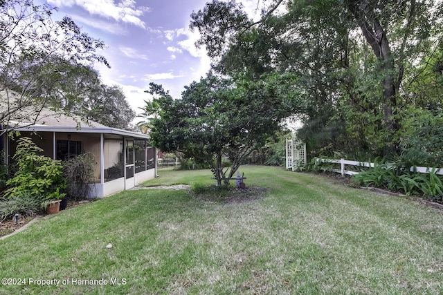 3472 Hartley Rd, Spring Hill, FL 34606 - view of green lawn with a sunroom