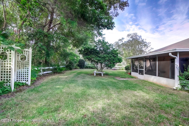 view of yard featuring a sunroom