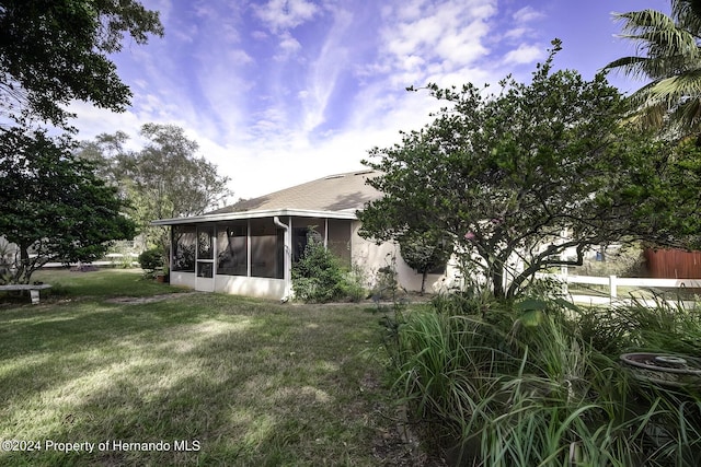 3472 Hartley Rd, Spring Hill, FL 34606 - back of property featuring a sunroom and a lawn