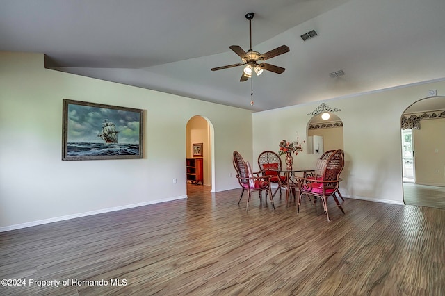 dining space featuring wood-type flooring, ceiling fan, and vaulted ceiling