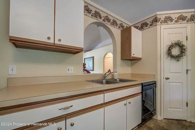 kitchen with white cabinetry, sink, and black dishwasher