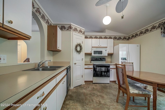 kitchen with lofted ceiling, decorative light fixtures, sink, white cabinetry, and white appliances