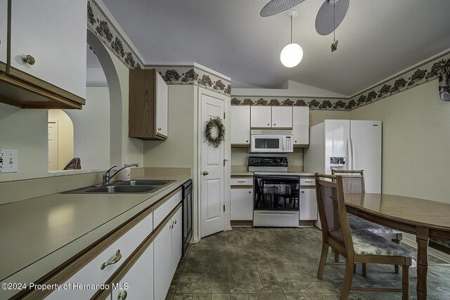 3472 Hartley Rd, Spring Hill, FL 34606 - kitchen with white appliances, a sink, white cabinets, vaulted ceiling, and light countertops
