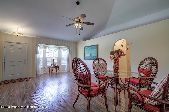 dining space featuring hardwood / wood-style flooring, ceiling fan, and lofted ceiling