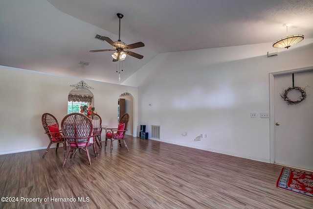 dining room featuring lofted ceiling, ceiling fan, and wood-type flooring