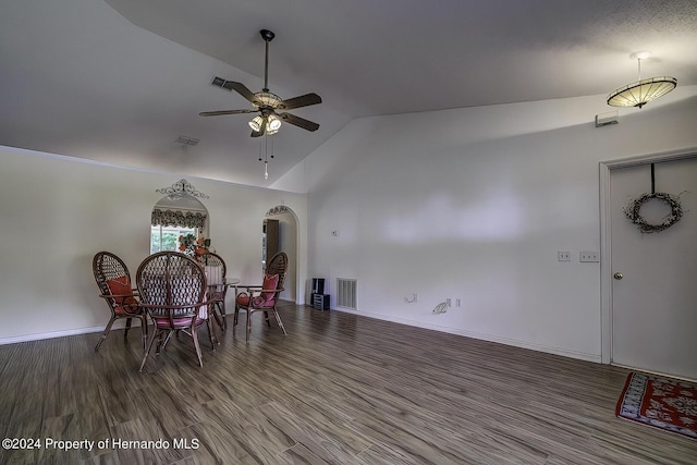 3472 Hartley Rd, Spring Hill, FL 34606 - dining area featuring a ceiling fan, arched walkways, wood finished floors, baseboards, and high vaulted ceiling