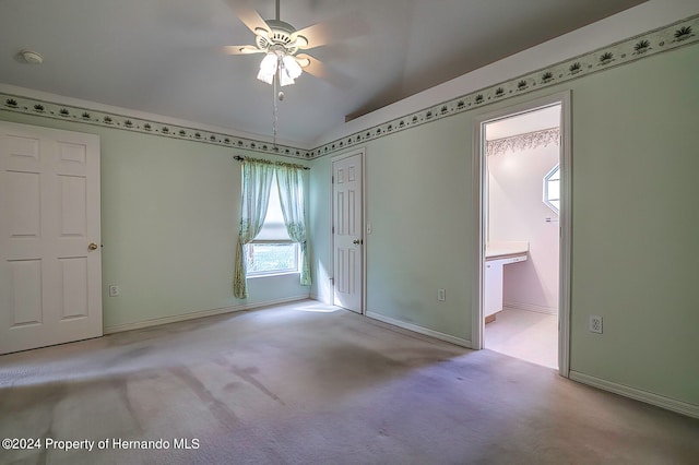 carpeted empty room with ceiling fan, cooling unit, and vaulted ceiling