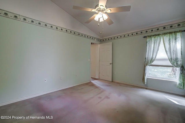 carpeted empty room featuring ceiling fan and vaulted ceiling