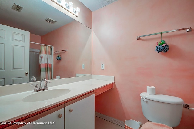 bathroom featuring walk in shower, vanity, and toilet