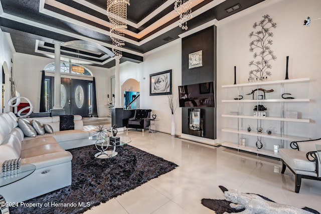 tiled living room featuring a raised ceiling and crown molding