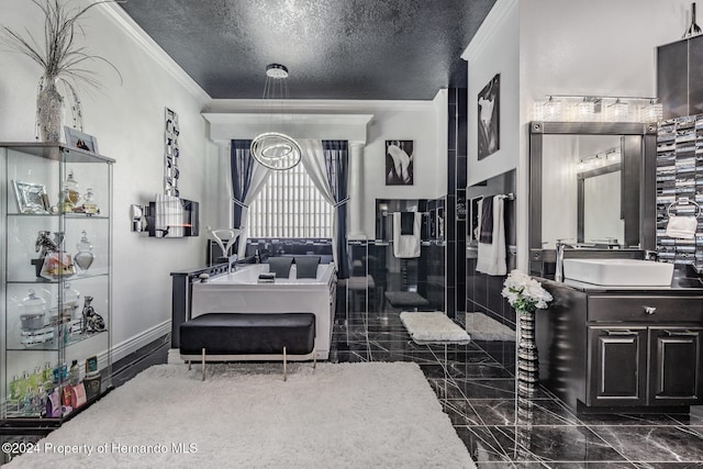 bathroom featuring vanity, a tub to relax in, a textured ceiling, and ornamental molding