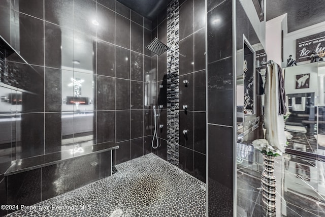 bathroom with a tile shower