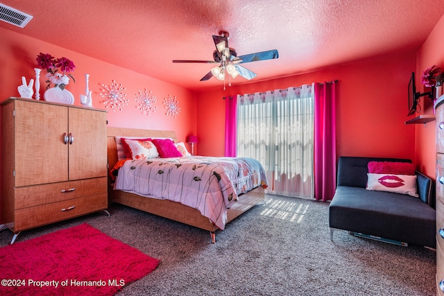 bedroom featuring ceiling fan, a textured ceiling, and carpet