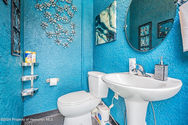 bathroom featuring tile patterned flooring and toilet