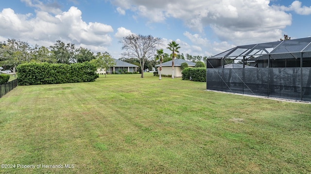 view of yard with glass enclosure