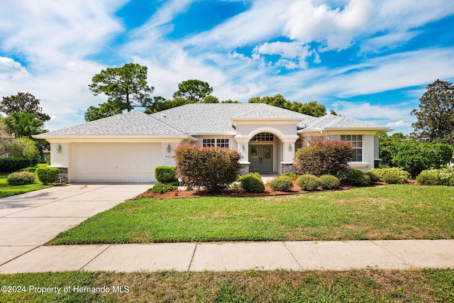 view of front of property featuring a garage and a front yard