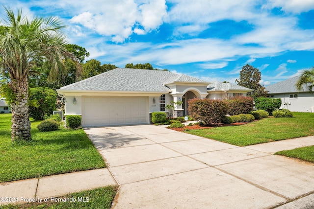 view of front facade featuring a front lawn and a garage