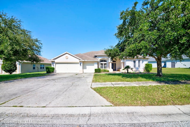 single story home with a front lawn and a garage