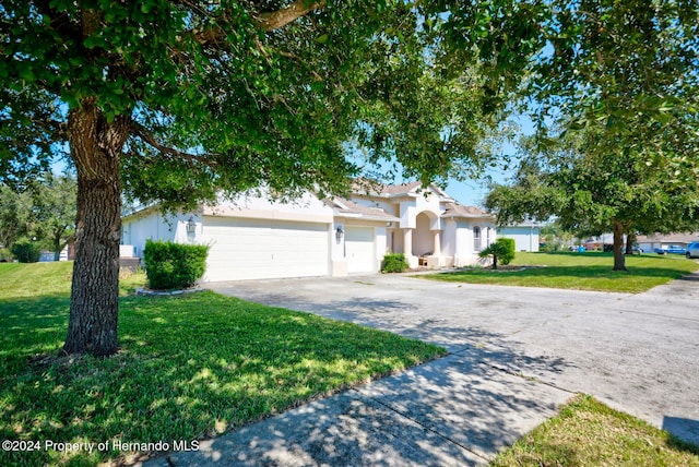 view of front of property with a garage and a front lawn