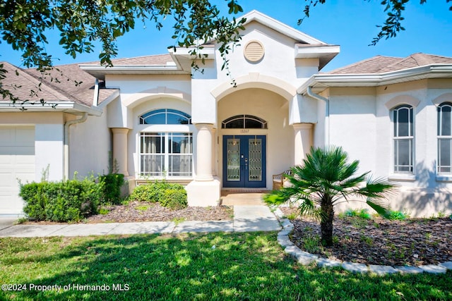 exterior space with a garage and french doors