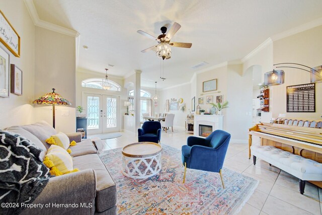 tiled living room featuring french doors, ceiling fan, and crown molding