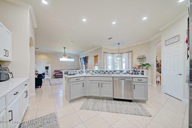 kitchen featuring white cabinetry, hanging light fixtures, and stainless steel dishwasher