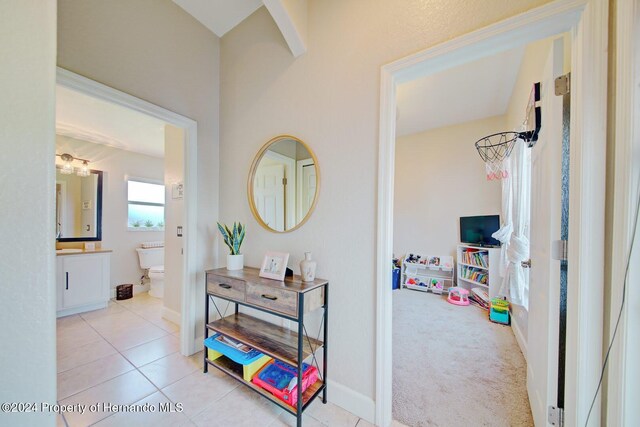 hallway featuring light colored carpet