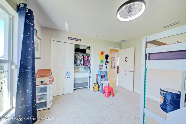 carpeted bedroom featuring a closet