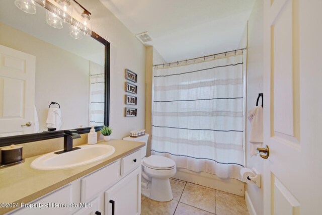 full bathroom with tile patterned flooring, vanity, shower / bath combination with curtain, and toilet