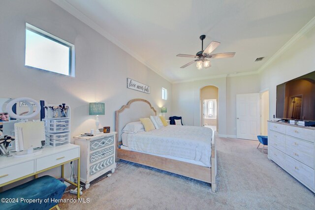 carpeted bedroom featuring ceiling fan, crown molding, and multiple windows