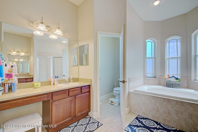 full bathroom featuring separate shower and tub, tile patterned flooring, vanity, and toilet