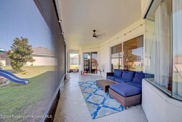 sunroom featuring ceiling fan