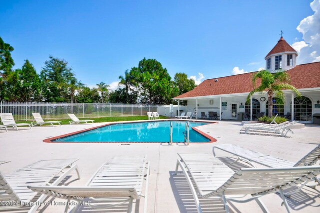 view of swimming pool with a patio