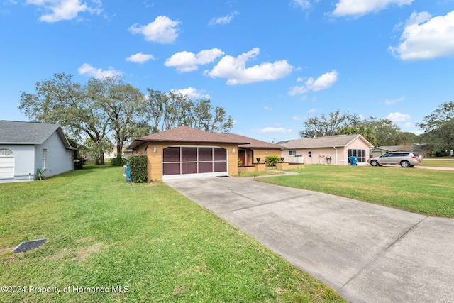 ranch-style house featuring a front lawn and a garage